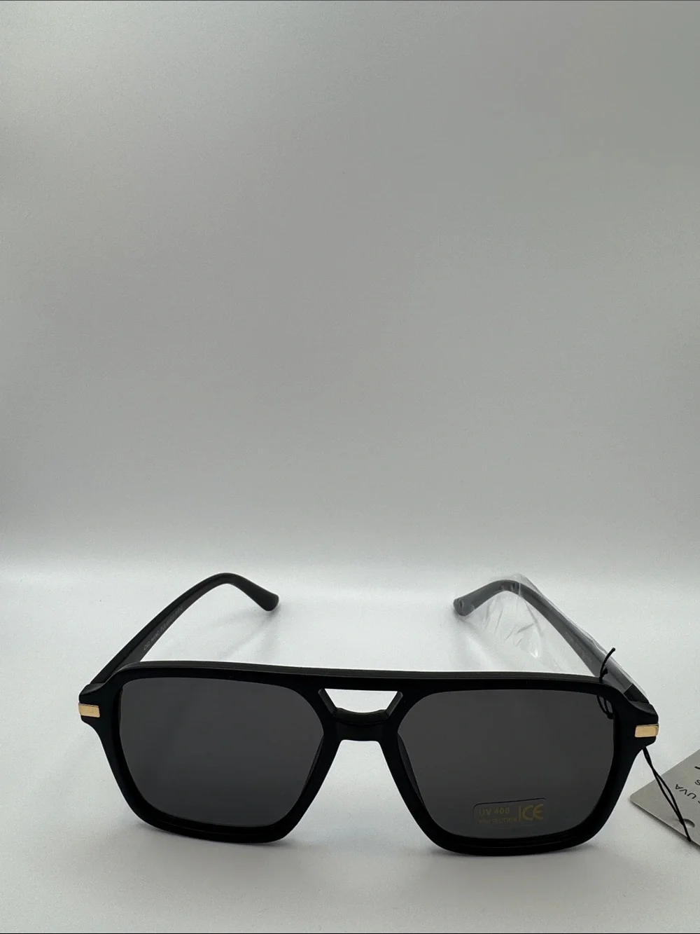 Black Sunglasses with Dark Lenses and Gold Accents
